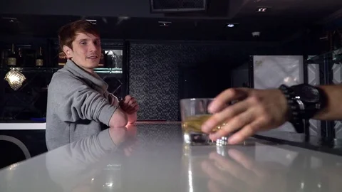 The barman serves a cocktail to the client Stock Footage 85130618