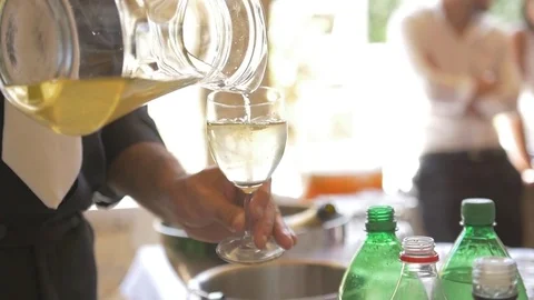Barman serves fresh drink in glass at summer party in Slowmotion Stock Footage