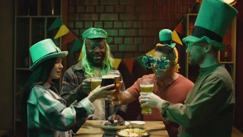 Barman Serving Beer to Diverse Friends Celebrating St Patricks Day Stock Footage 261498745