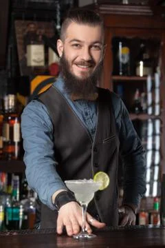 Barman serving cocktail. Stock Photos