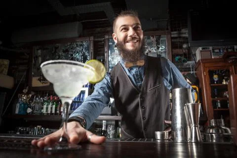 Barman serving cocktail. Stock Photos