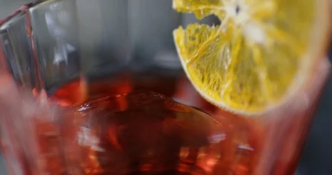 The barman serving a mixed alcoholic negroni drink in a bar. Close up shot on 6k Stock Footage 106468164