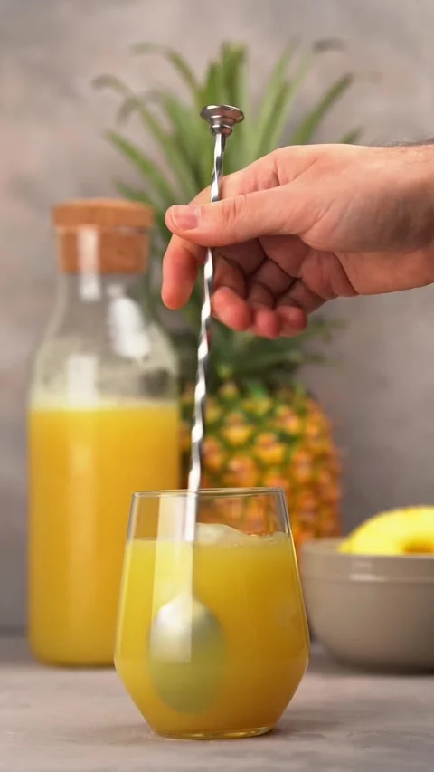 Barman stirring with bar spoon a pineapple cocktail. Stock Footage 231494366