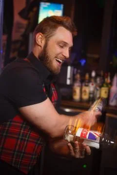 Barman throws a bottle in the air Stock Photos