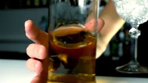 The barman's hand catches a bottle of alcohol Stock Footage
