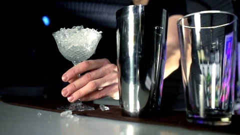 The barman's hand puts on the bar a glass of ice Stock Footage 77828195