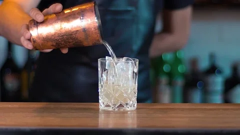 The barman's making a cocktail at the bar. Stock Footage 130781676