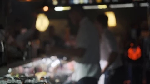 Barmans work at the bar and pour drinks into glasses Stock Footage 121804409