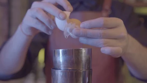 Barmen breaks an egg to make a cocktail Stock Footage 109016462
