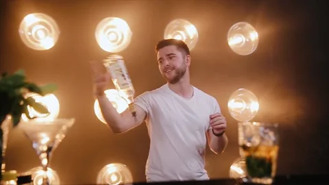 Barmen near bar counter performs juggling show. Professional bartender juggling Stock Footage 151417285