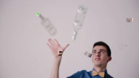 Barmen performs juggling show. Professional bartender man juggling bottles Stock Footage 164873990
