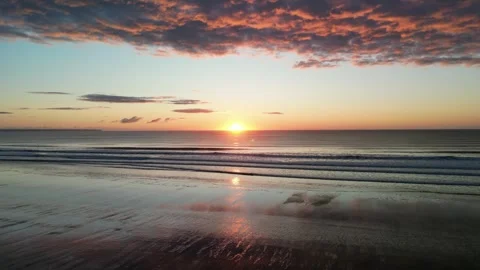Barmston Beach drone footage pull back and lift sun rise Stock Footage 247490688