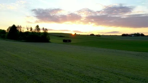Barn on a meadow during sunset Stock Footage 131984185