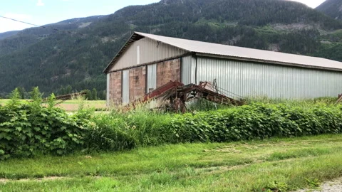 Barn in mountain valley field Stock Footage 146989380