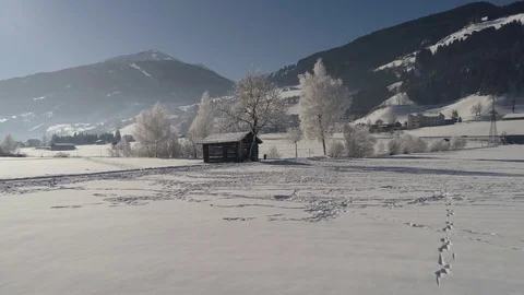 Barn in the snow-covered field Stock Footage 72165752