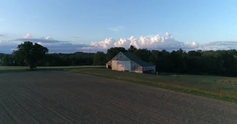 A barn surrounded by a wheat field in the rural Pennsylvania countryside during  Video stock 133732517