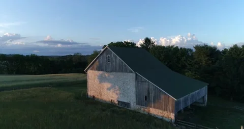 A barn surrounded by a wheat field in the rural Pennsylvania countryside during  Stock Footage 133732611
