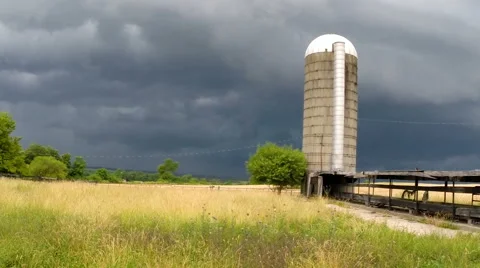 Barn view of storm coming to farm Stock Footage