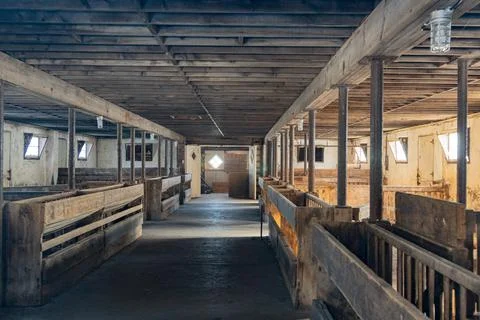 A barns sits empty of horses on a cold wintery day. Stock Photos