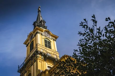 Baroque clock tower dark spire Óbuda Town Hall Budapest low angle Stock Photos