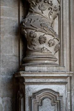 Baroque column base with intricate grapevine carvings in stone Stock Photos