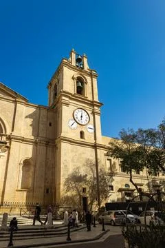 The baroque limestone bell tower of the Co-Cathedral with multiple astronom.. Stock Photos