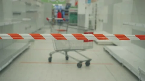 Barrage tape on the background of empty store shelves and a shopping cart Stock Footage 149108073