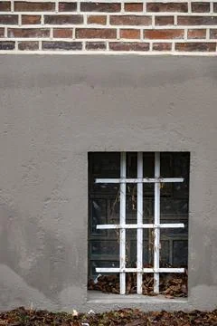 Barred cellar window in an old building Stock Photos