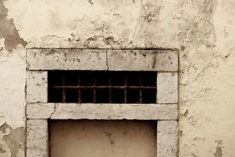 Barred transom window in plaster wall in Lisbon, Portugal Stock Photos