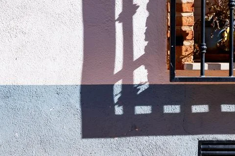 Barred window and its shadow in Alhambra Stock Photos