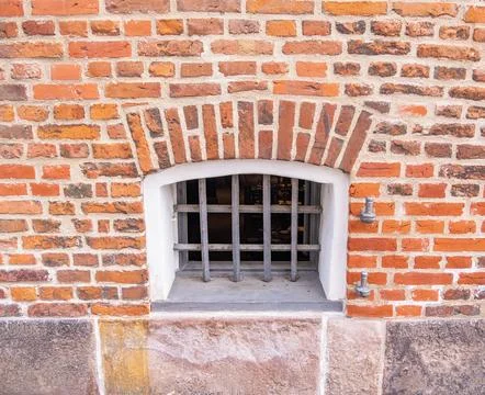 Barred Window in Brick Wall Stock Photos