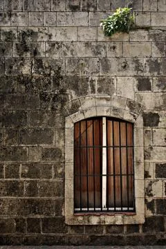 Barred Window on an Old Wall Stock Photos