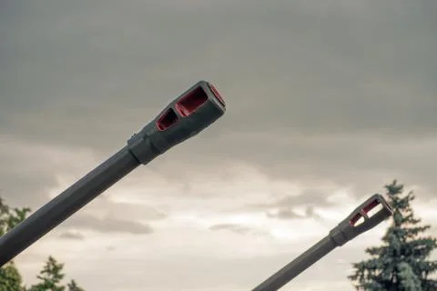 Barrel of an artillery gun on the background of dramatic cloudy sky close-up Stock-Fotos