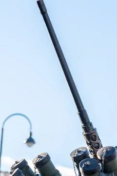 The barrel of a heavy machine gun mounted on an armored vehicle against the blue 스톡 사진