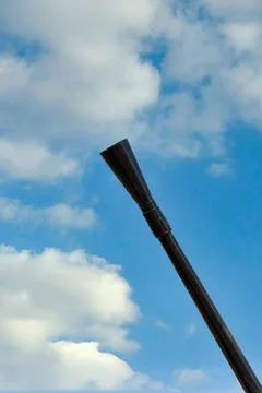 Barrel of a machine gun in a diagonal frame against a blue sky Stock Photos