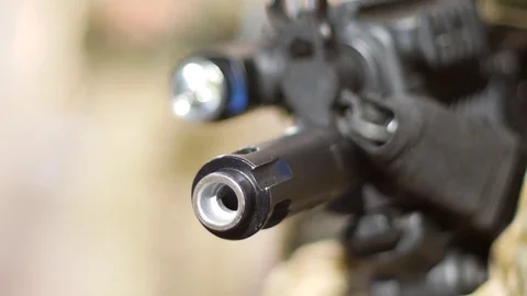 Barrel of submachine gun in the hands of peacemaker Stock Footage 79339311