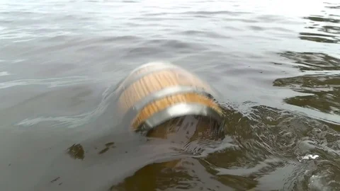 A barrel of wood floating on the waves in the sea Stock Footage