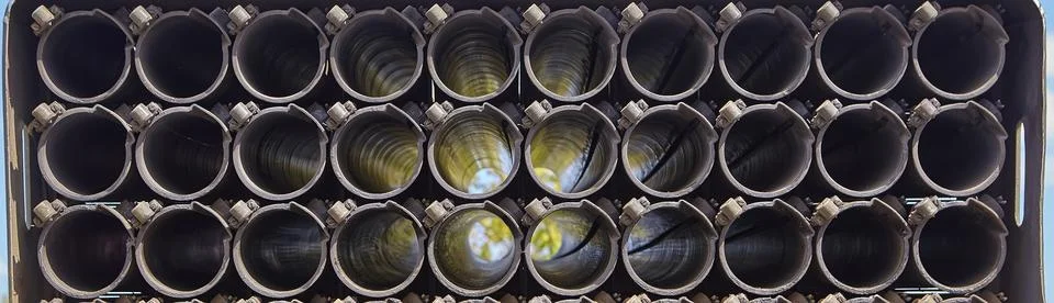 Barrels of multiple launch rocket systems, background. Stock Photos