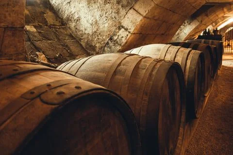 Barrels in a rustic wine cellar Stock Photos
