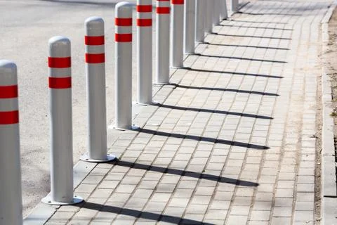 A barrier made of plastic columns with reflective pigment on an asphalt road Stock Photos