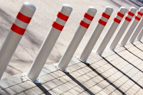 A barrier made of plastic columns with reflective pigment on an asphalt road Stock Photos