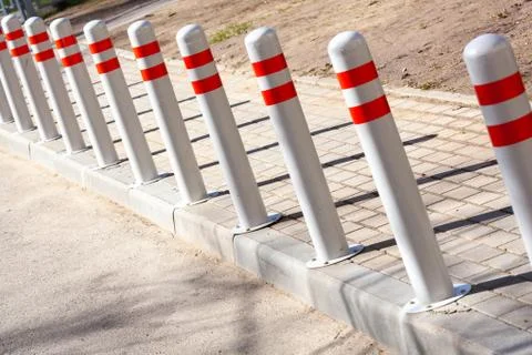 A barrier made of plastic columns with reflective pigment on an asphalt road Stock Photos