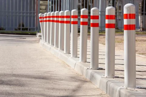 A barrier made of plastic columns with reflective pigment on an asphalt road Stock Photos