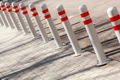 A barrier made of plastic columns with reflective pigment on an asphalt road Stock Photos