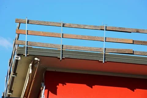 Barrier is a practical solution for protecting workers from falling during .. Stock Photos