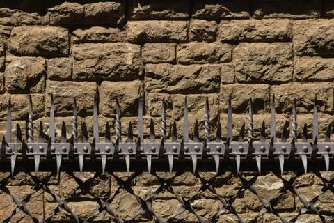Barrier with security prongs and solid stoned wall Stock Photos