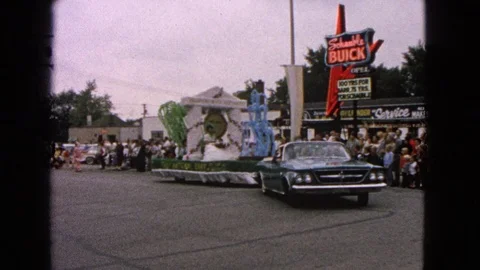 BARRINGTON ILLINOIS USA-1963: Parade Float Passes Buick Dealership Stock Footage 123764166