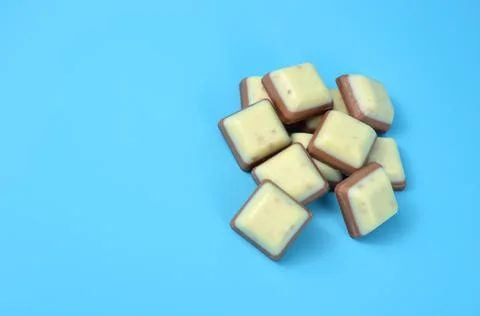 Bars of chocolate on a blue background. Stock Photos