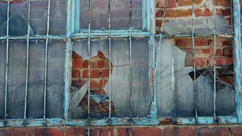 Bars on a derelict old building window wide shot Stock Footage 250111804