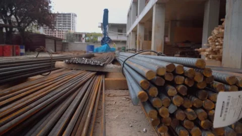 Bars of reinforcement are stacked in yard of construction site. Stock Footage 197853252